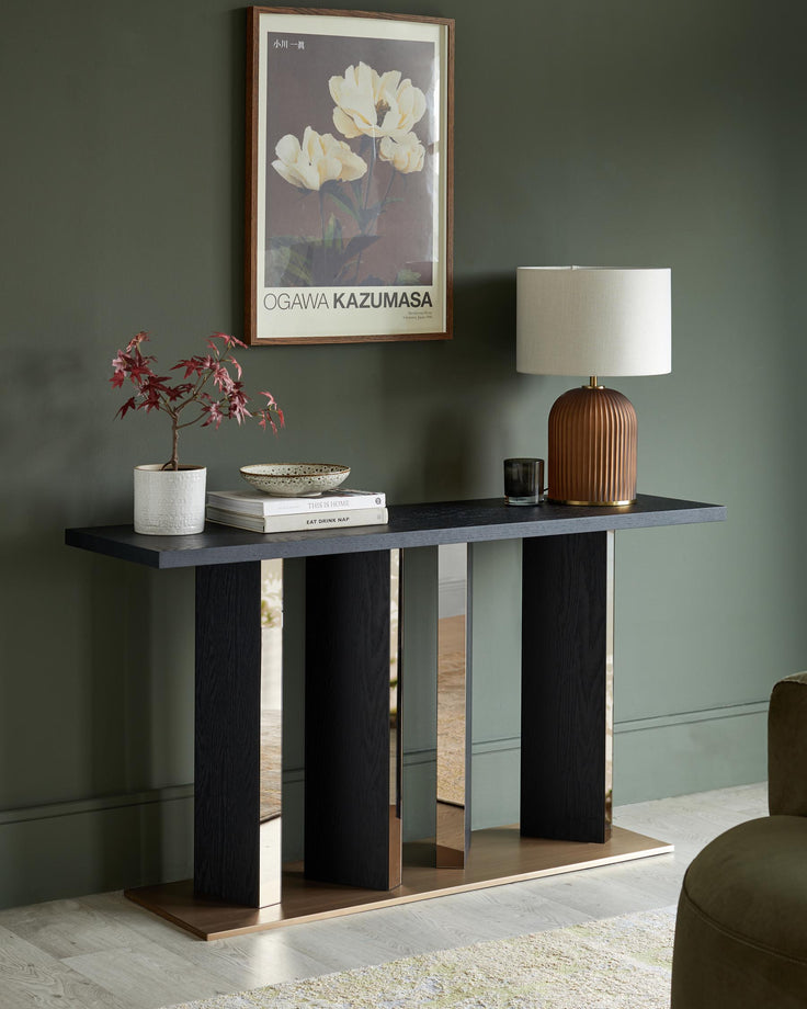 Contemporary console table with a sleek, dark top and mirrored accents, creating a stylish statement piece for modern interiors.