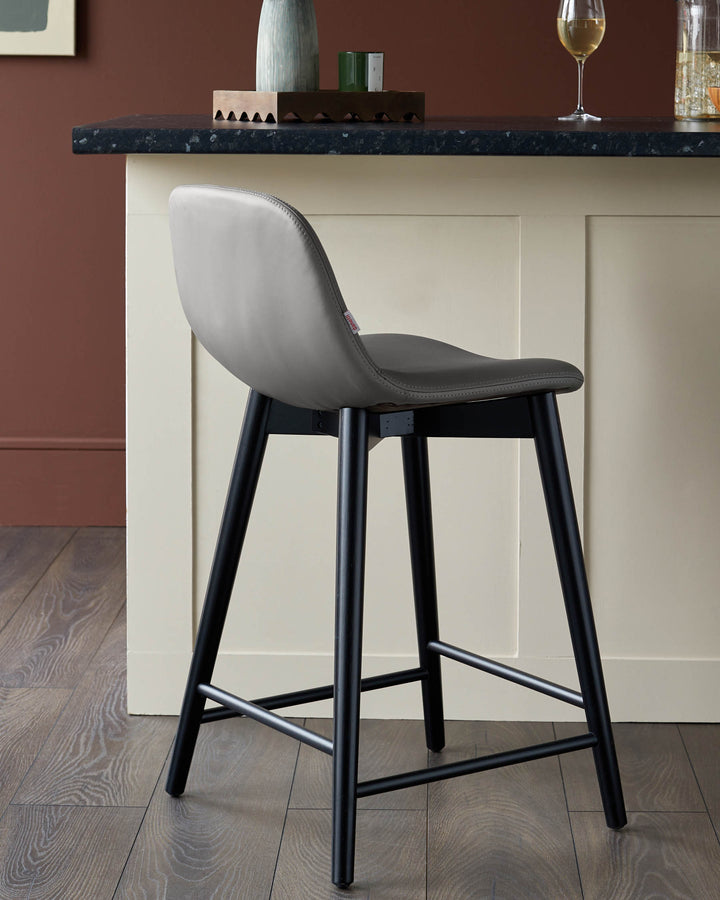 A stylish grey bar stool with black legs, adding a touch of modern elegance to your kitchen or bar area.