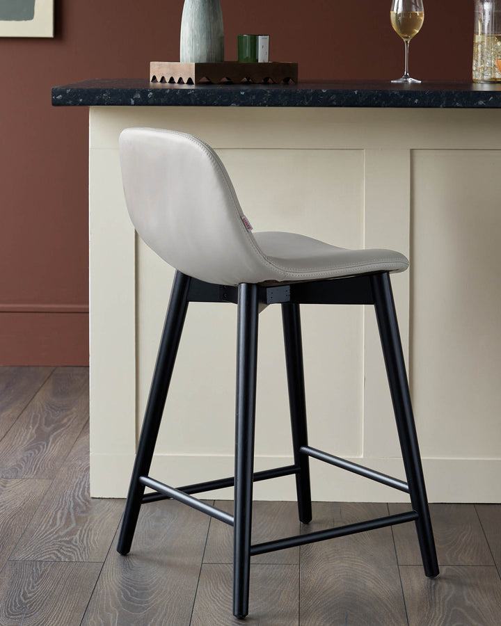 A stylish bar stool with a light grey seat and black legs. Perfect for adding a touch of modern elegance to your kitchen.