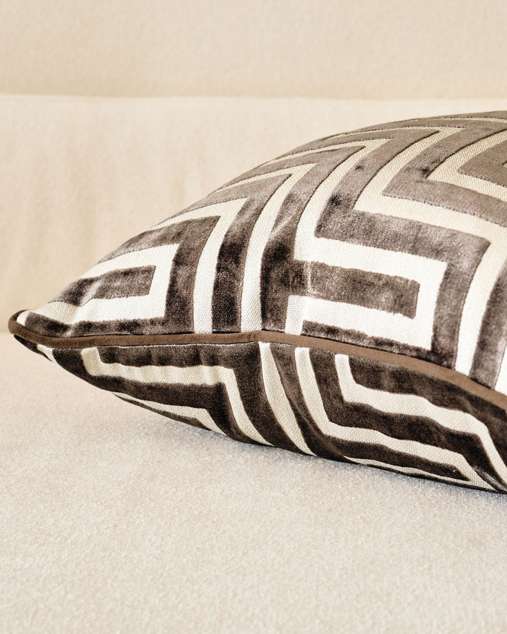 Imani medium cushion in chocolate, featuring geometric chevron pattern in taupe and cream with leather handle detail.