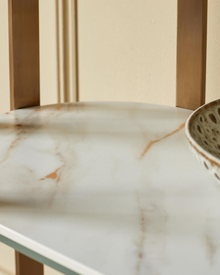 A close-up of a stylish side table with a marble top and wooden frame, ideal for adding elegance to any room.