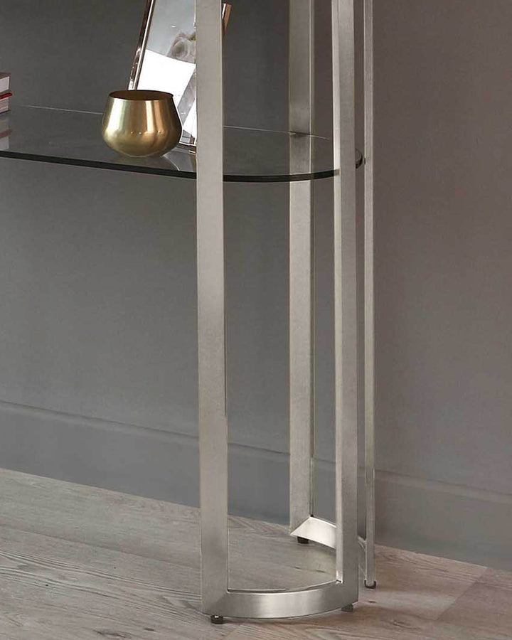 Isla glass and stainless steel console table with white frame, displaying gold bowl on glass shelf.