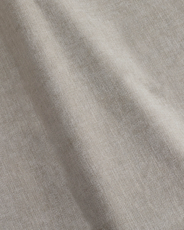 Close-up of textured, crumpled fabric in a neutral colour. Suitable for upholstery or soft furnishings.