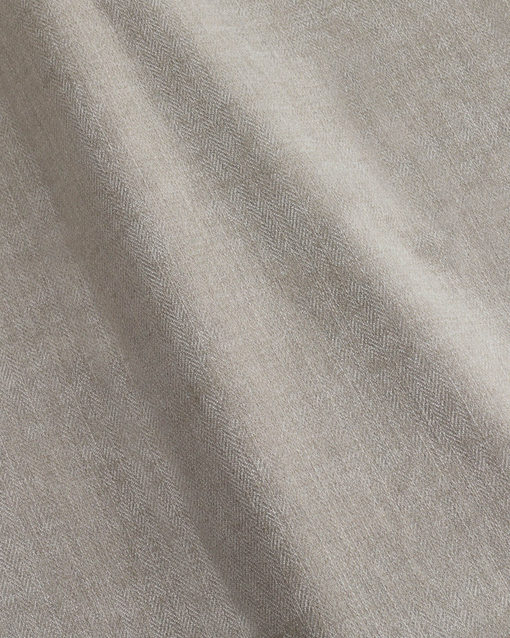 Close-up of textured, crumpled fabric in a neutral colour. Suitable for upholstery or soft furnishings.