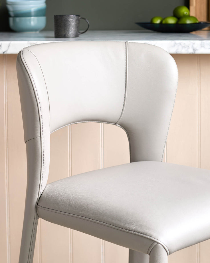 Jackson bar stool in light grey real leather, shown at an angle highlighting the curved backrest and seat.