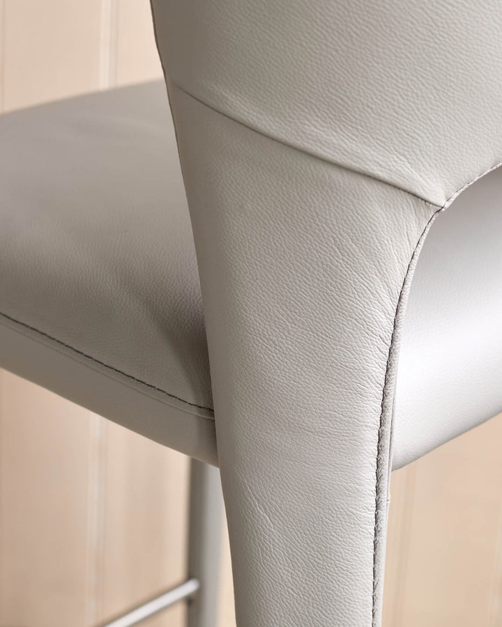 Light grey leather Jackson bar stool, close-up of armrest and stitching detail.