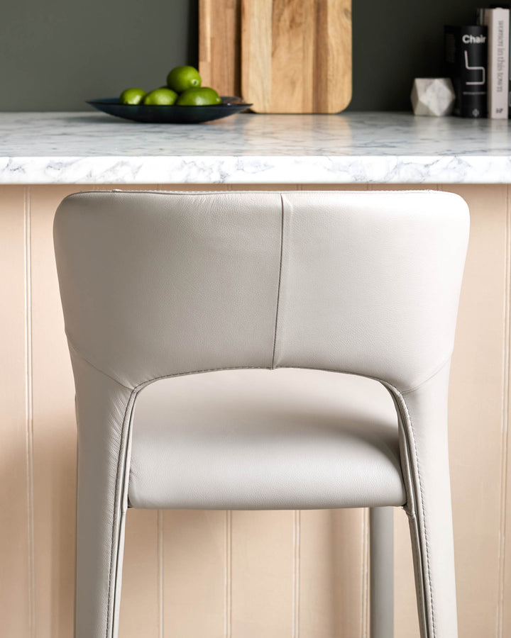 Jackson bar stool in light grey real leather, shown from behind with curved backrest and modern design.