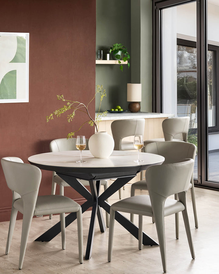 Jackson dining chair in light grey real leather, shown in a modern dining setting around a round table.