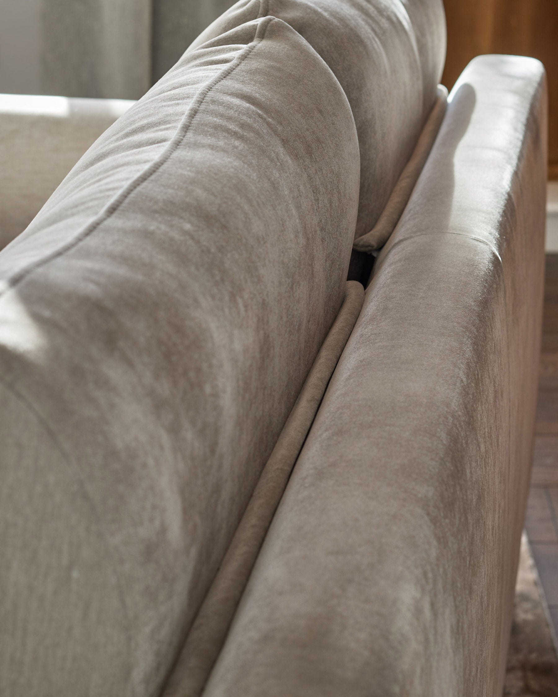 Jacob 3-seater sofa in light grey fabric, close-up of armrest and seat cushions showing texture and weave detail.