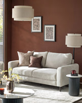 Jacob 3-seater sofa in light grey fabric, displayed in a styled living room setting with decorative pillows.