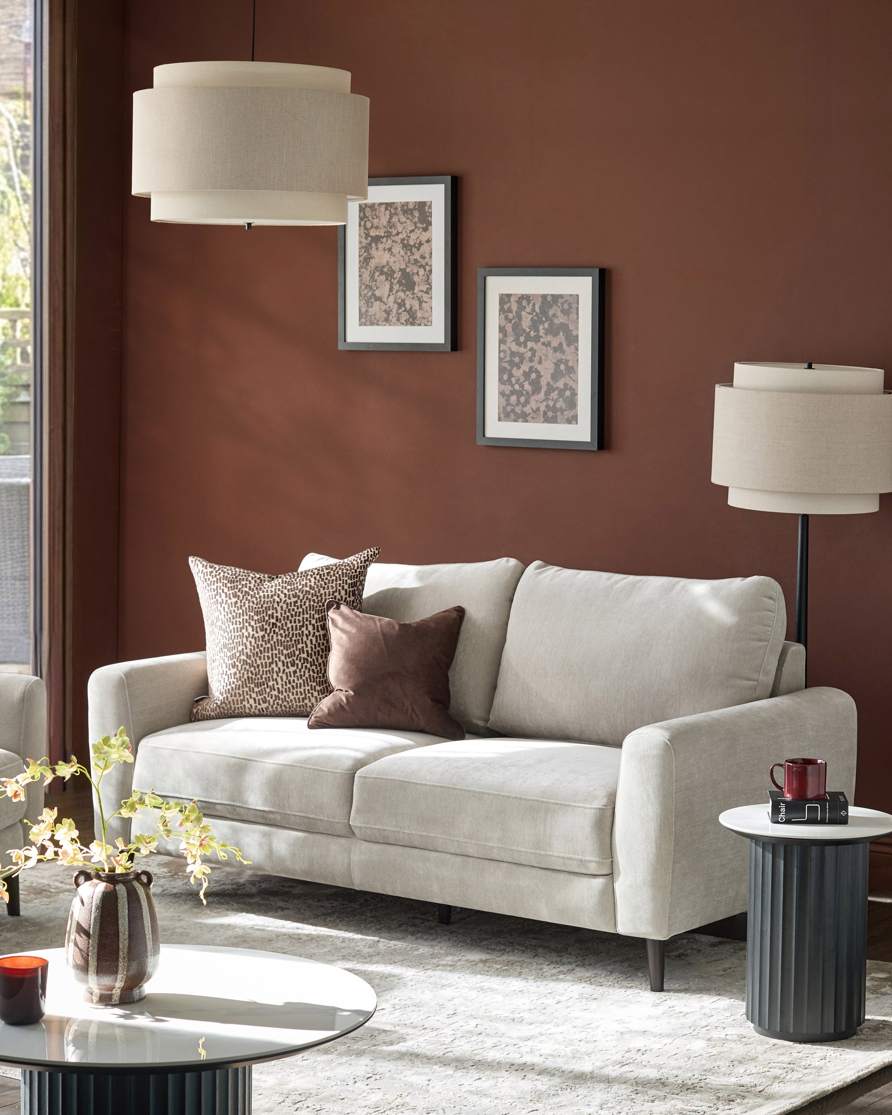 Jacob 3-seater sofa in light grey fabric, displayed in a styled living room setting with decorative pillows.