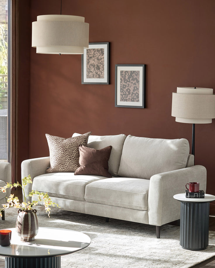 Jacob 3-seater sofa in light grey fabric, displayed in a styled living room setting with decorative pillows.