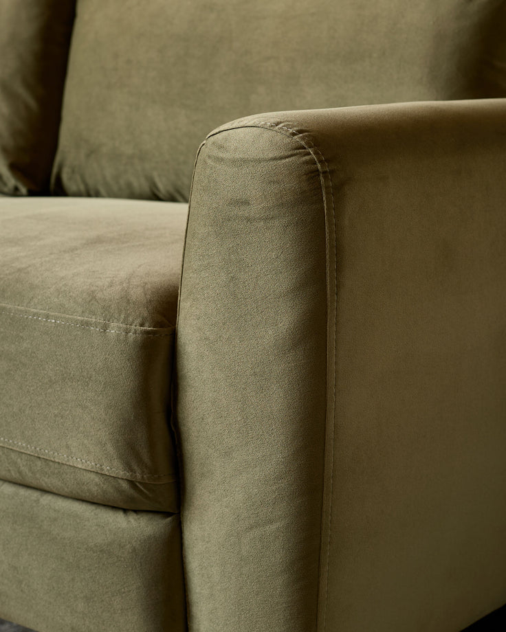 Close-up of olive green velvet armrest on Jacob 3-seater sofa, showing fabric texture and piping detail.