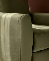 Jacob armchair in olive green velvet, close-up of rolled armrest and seaming detail.