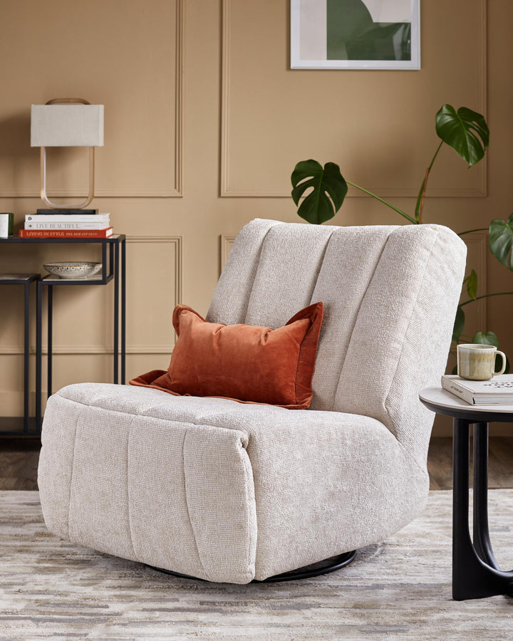 A stylish swivel chair with a plush orange cushion, complemented by modern side tables and a warm, inviting backdrop.