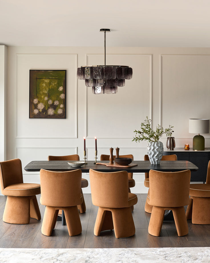 Caramel fabric swivel dining chair with curved back and wooden legs in modern dining room setting.