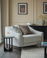 Julep Blackwood Armchair in grey fabric, shown in a styled living room setting with coordinating pillows and black side tables.