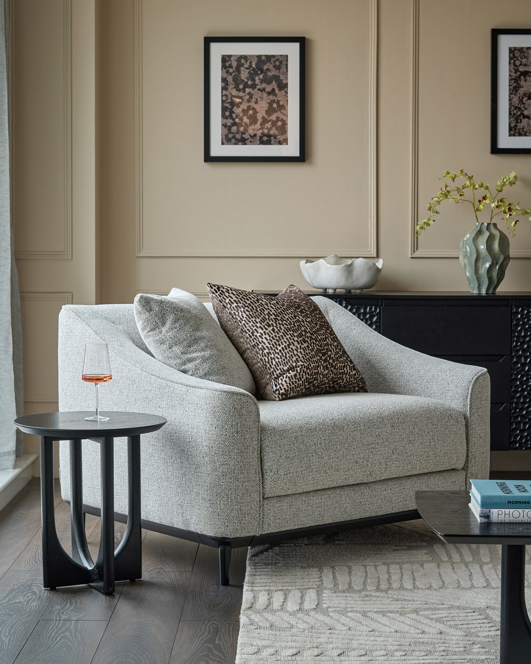 Julep Blackwood Armchair in grey fabric, shown in a styled living room setting with coordinating pillows and black side tables.