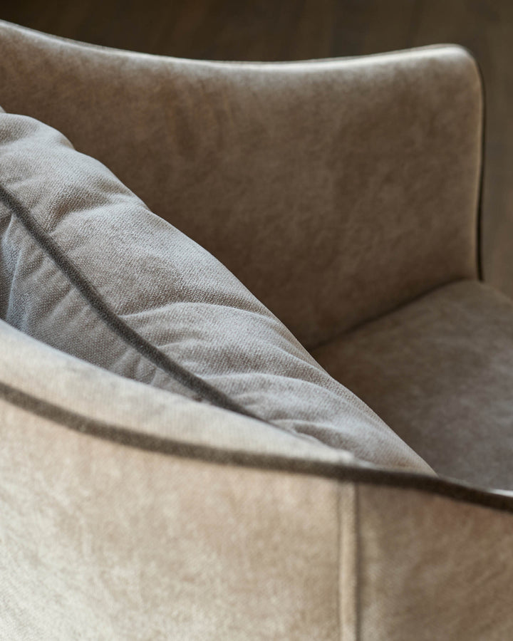 Julep dining chair in champagne fabric, close-up detail showing curved backrest and soft upholstery texture.