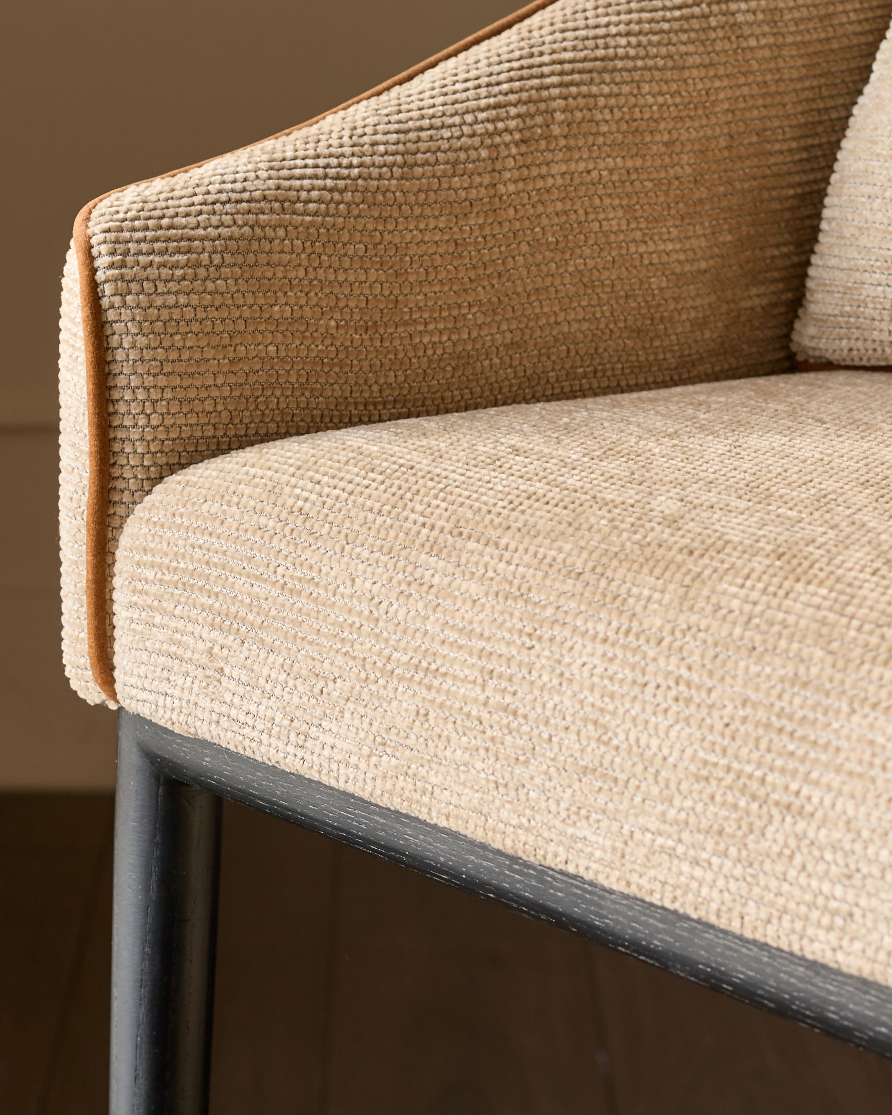 Julep bar stool in honey fabric, close-up detail of seat and backrest showing textured weave and dark wooden frame.