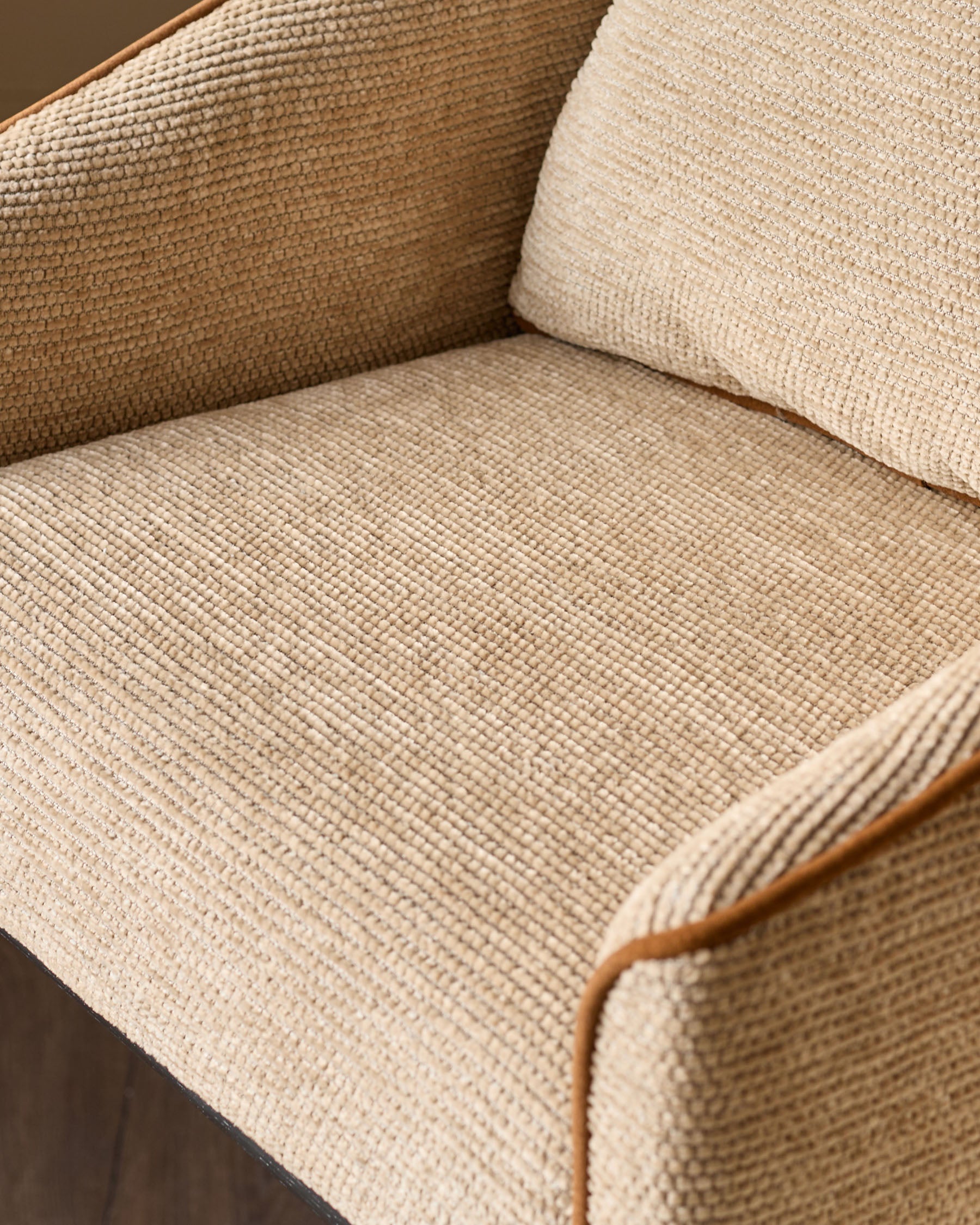 Julep bar stool in honey fabric, close-up view showing textured weave and wooden armrest detail.
