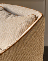 Julep bar stool in honey fabric, close-up of rolled arm detail with tan upholstery and wood trim.