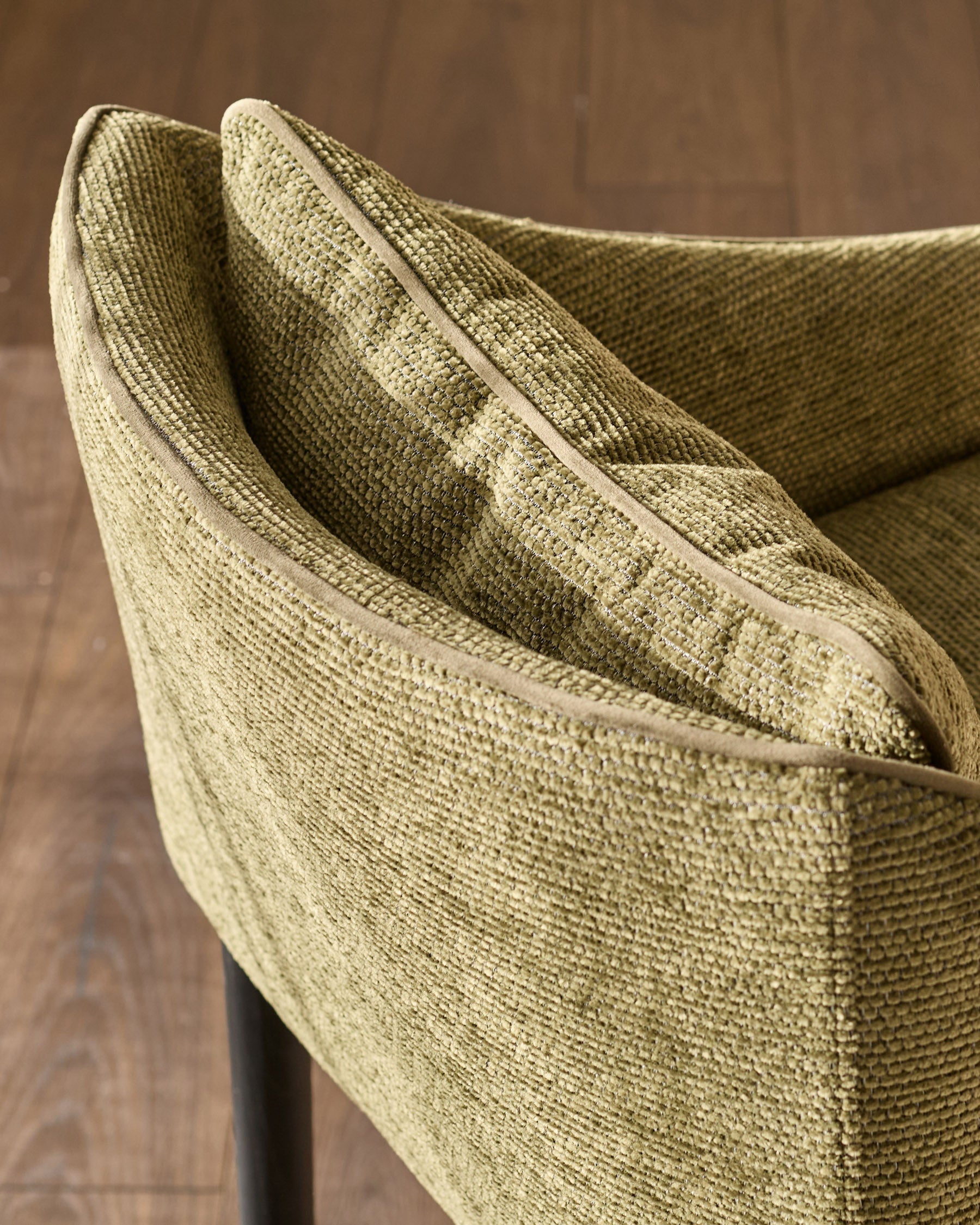 Julep bar stool in olive green fabric, close-up of curved backrest and woven texture detail.