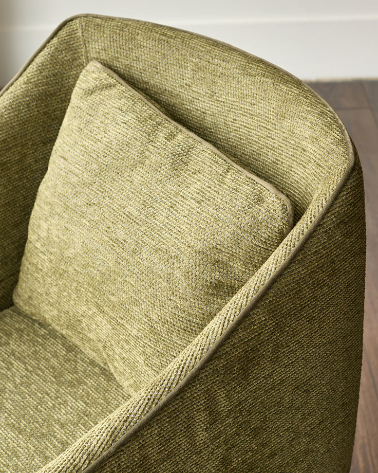 Julep dining chair in olive green fabric, close-up detail of cushioned backrest and piping.