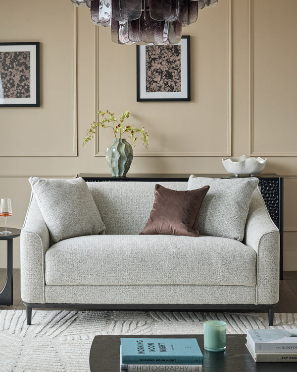 Julep grey 2-seater sofa with rolled arms and black wooden legs in a neutral living room setting.