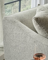 Julep Blackwood 2-seater sofa in grey fabric, close-up detail showing textured weave and curved armrest by window.