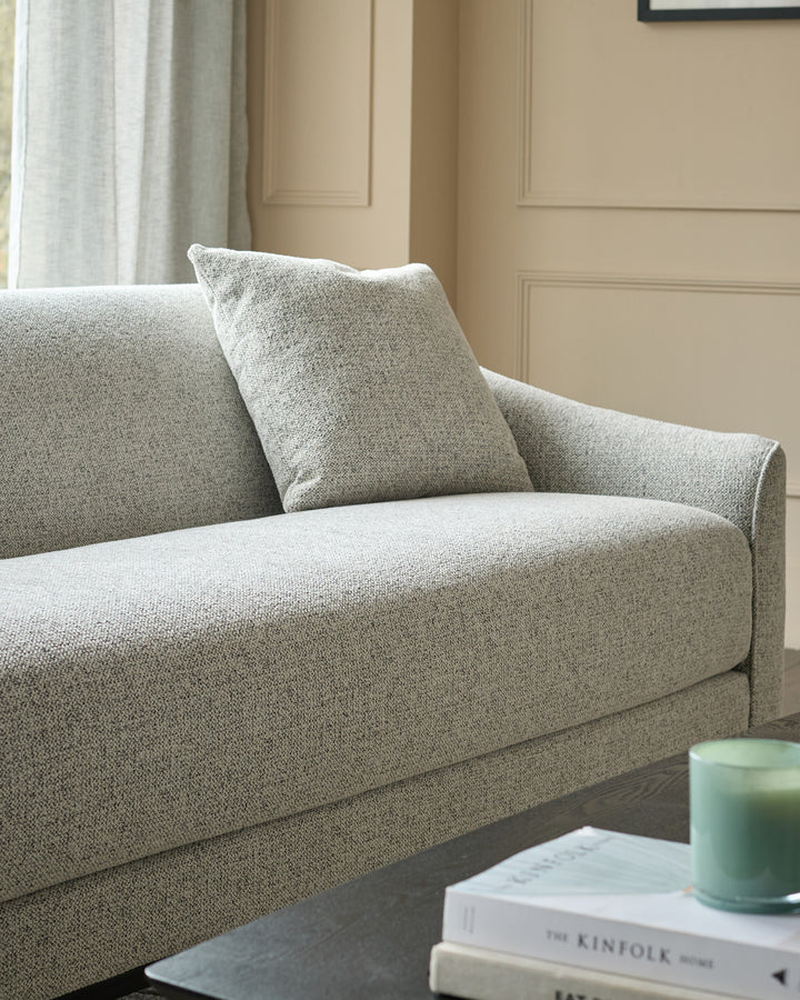 Julep Blackwood 3-seater sofa in grey fabric, shown at an angle with a matching scatter cushion.