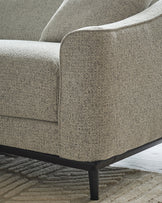 Grey fabric 2-seater sofa with curved armrests and black wooden legs, shown at close-up side angle.