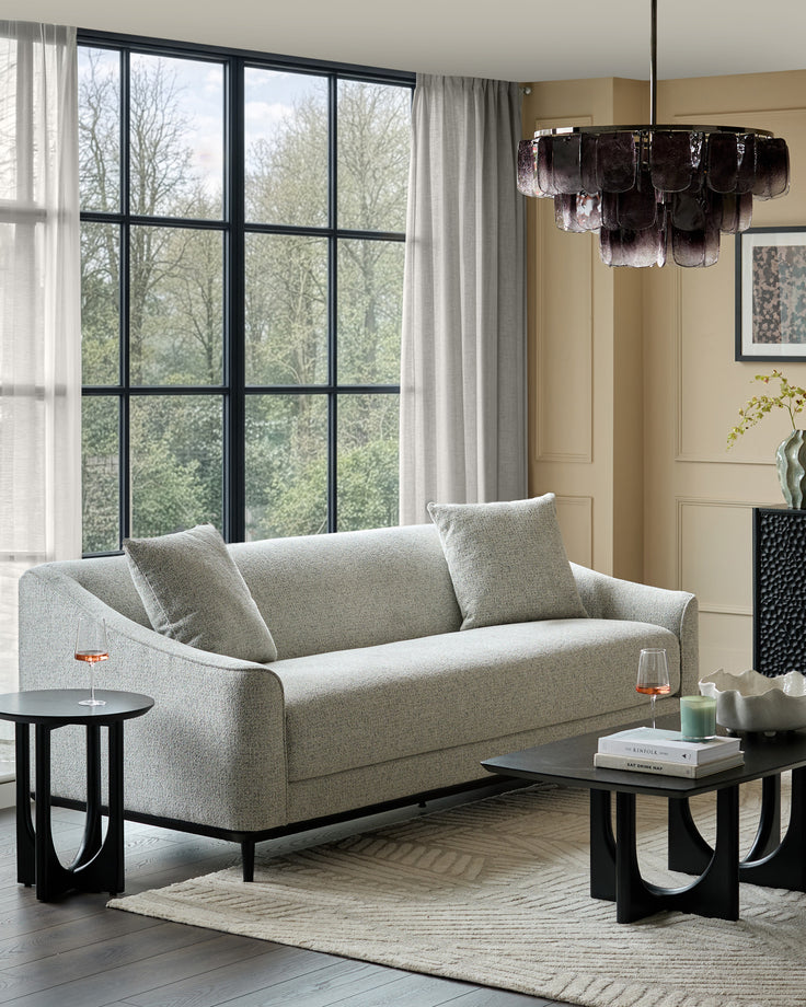 Julep grey fabric 3-seater sofa with black wooden legs, shown in a contemporary living room setting with accent pillows.