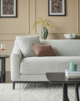 Julep grey fabric 3-seater sofa with rolled arms and black wooden legs, styled in a neutral living room setting.