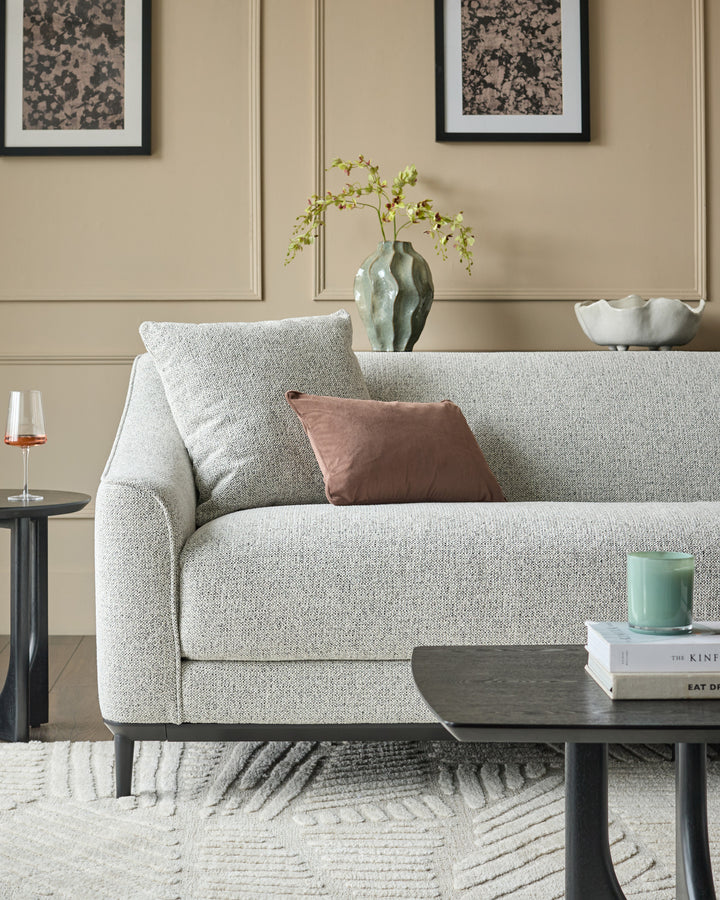 Julep grey fabric 3-seater sofa with rolled arms and black wooden legs, styled in a neutral living room setting.