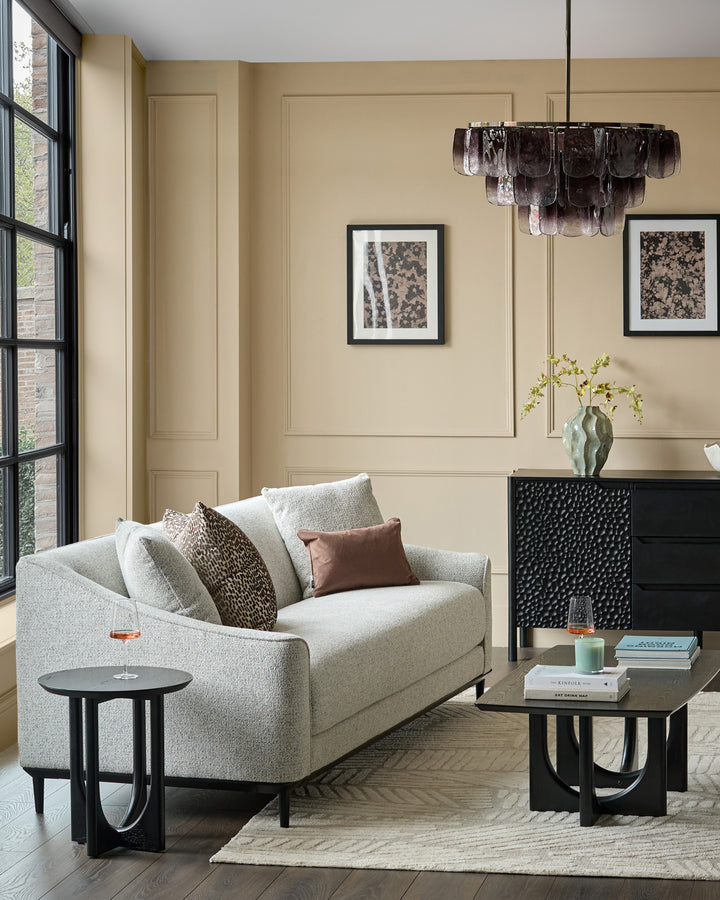 Julep grey fabric 3-seater sofa with curved arms, styled in a modern living room with black side table and pendant light.