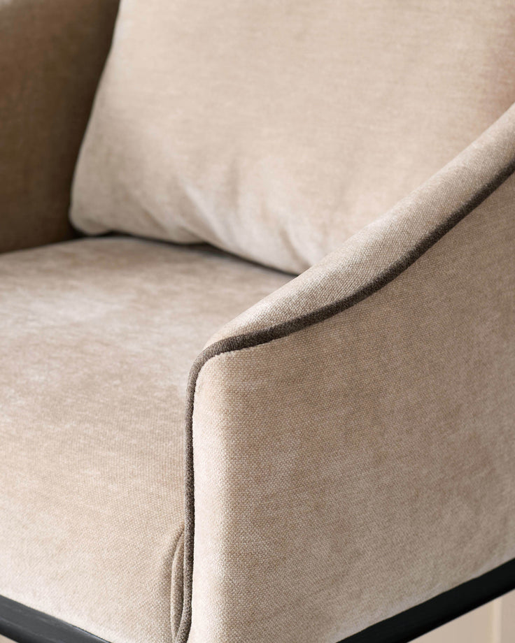 Champagne fabric bar stool, close-up of curved armrest and seat upholstery detail.