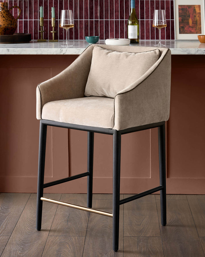 Champagne fabric bar stool with black metal frame and footrest, shown at a kitchen island counter.