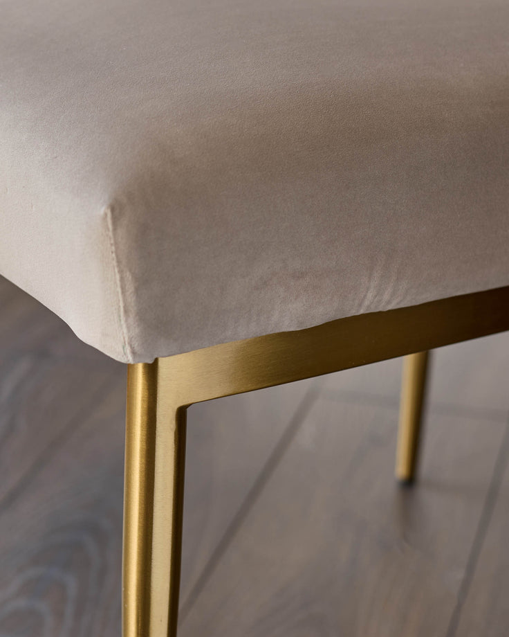 Keira velvet dining chair in champagne with gold metal frame, shown in close-up detail.