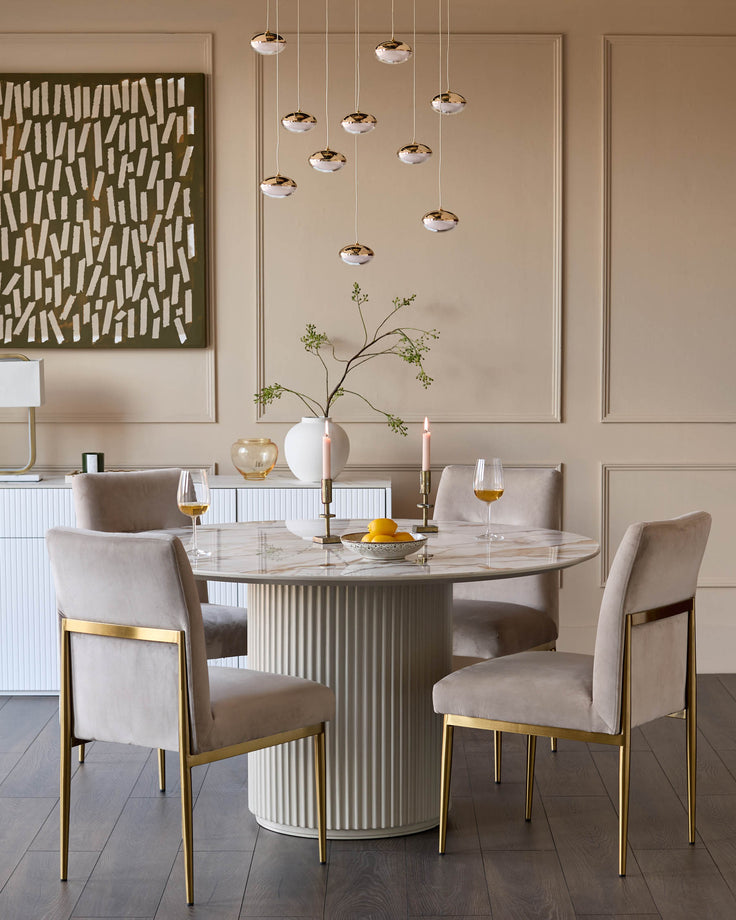 Keira Velvet Dining Chair in Champagne with brass legs, shown in elegant dining room setting.