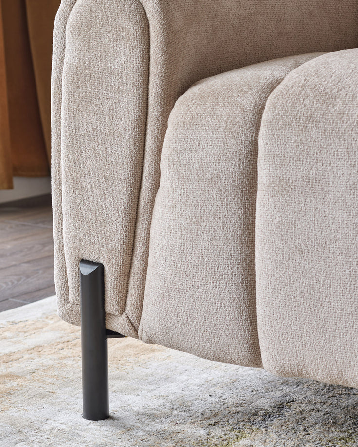 Kendra 3-seater sofa in natural fabric with curved arms and black metal leg detail, side view.