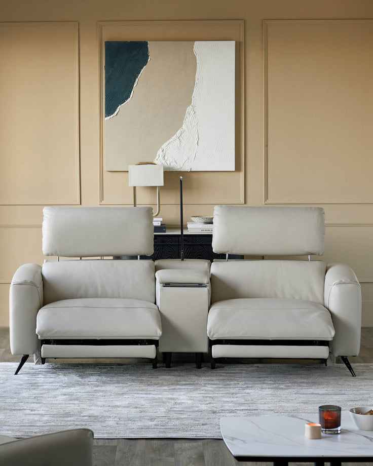 A contemporary off-white leather reclining sofa with headrests. Modern design with a stylish centre console.