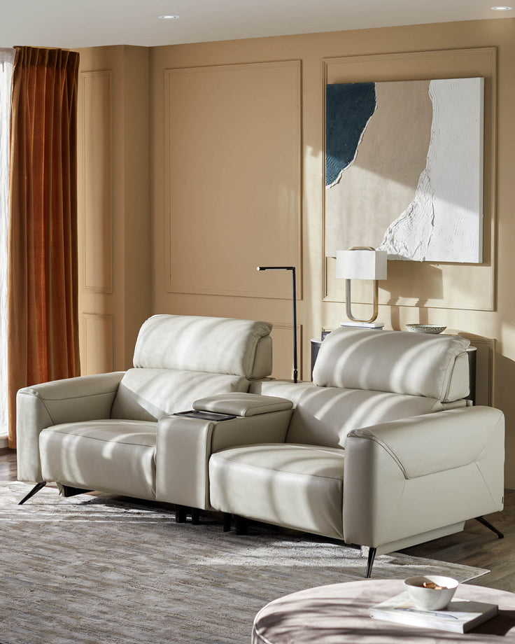 Stylish cream leather two-seater sofa with sleek black legs and a convenient centre console, perfect for modern living.