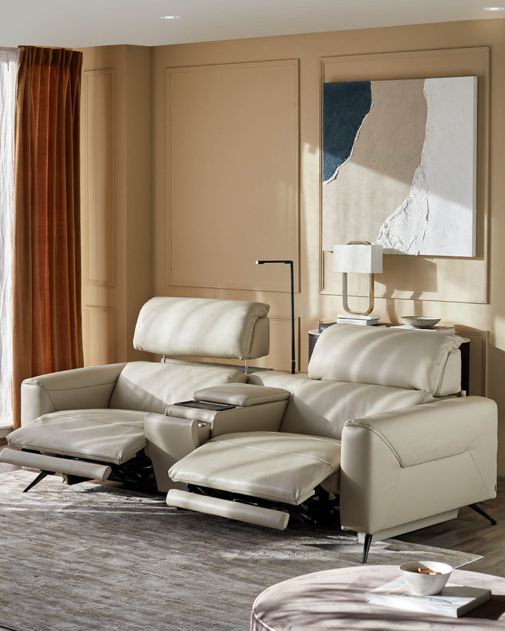 A luxurious, recliner sofa with headrests and a central console in a warm, neutral living room setting.