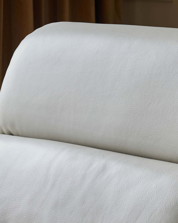 Close-up of a white leather sofa with a textured finish, showcasing premium quality and comfort.
