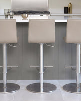 Kiki light grey real leather gas-lift bar stools with brushed stainless steel bases, shown in modern kitchen setting.
