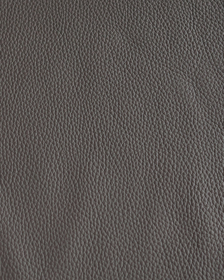 Close-up of grey leather. Subtle grain texture creates a sophisticated, timeless look.