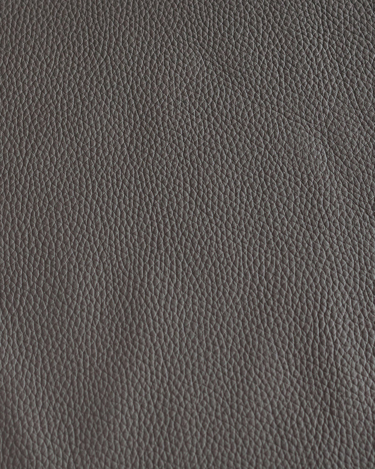 Close-up of grey leather. Subtle grain texture creates a sophisticated, timeless look.