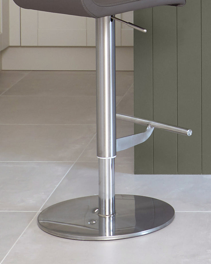 A modern, metallic bar stool with a padded seat and a circular base, perfect for any kitchen island.