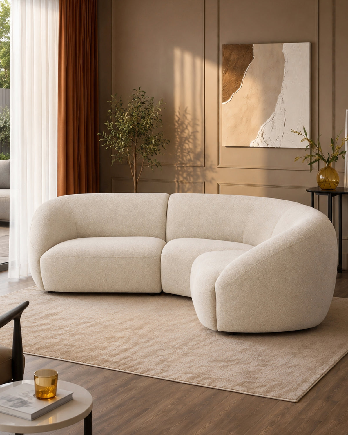 Kimberley square corner sofa in natural fabric with curved, rounded edges displayed in a modern living room setting.
